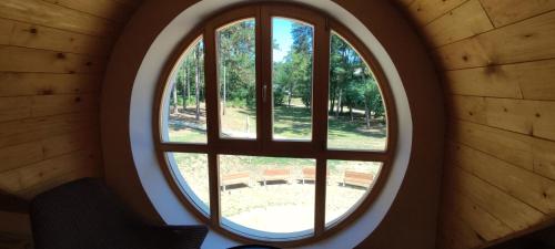 anorthole window in a building with a view of a park at Hostel Borik in Ðurđevac