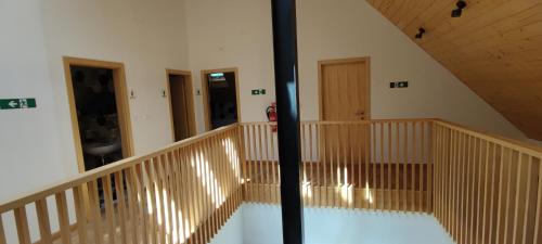 a room with a staircase with wooden railings in a building at Hostel Borik in Ðurđevac