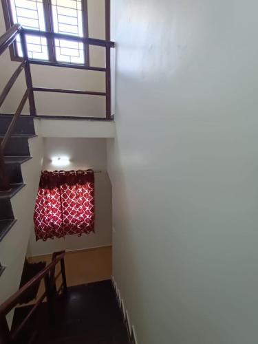 a stairway with a red curtain in a room at Coral Drive Villas -Your Private Beach Destination in Chennai