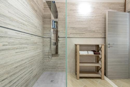 a bathroom with a shower and a small closet at Villa Tore in Quartu SantʼElena