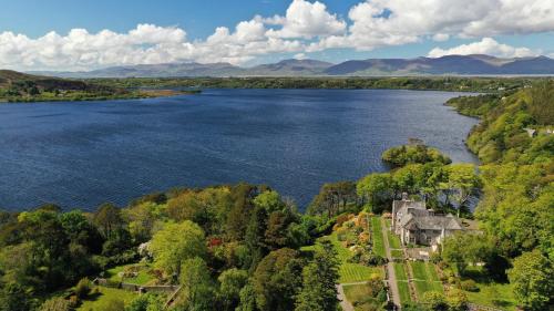 an aerial view of a house on the shore of a lake at Ard na Sidhe Country House Hotel in Killorglin