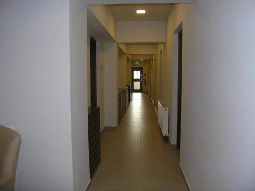 a long hallway with white walls and tile floors at Livadia Hotel Kyperounta in Kyperounda
