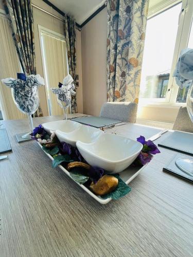 a table with a large white bowl on top of it at Laburnum Lodge with Hot Tub in York