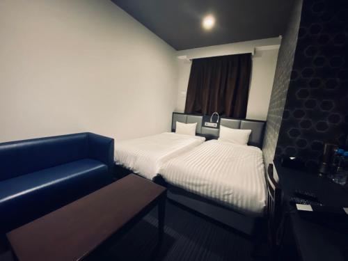 Postel nebo postele na pokoji v ubytování Hotel Hulaton Fukuokahakata