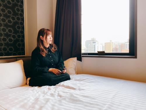 Postel nebo postele na pokoji v ubytování Hotel Hulaton Fukuokahakata