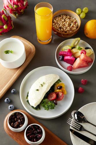 a table topped with plates of food and fruit at Shangri-La Qiantan, Shanghai - Steps away from the Oriental Sports Center, and easy reach the vibrant art scene of West Bund in Shanghai