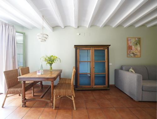 a dining room with a table and chairs and a couch at numa I Seda Apartments in Barcelona