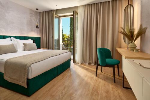 a bedroom with a bed and a desk and a chair at Hotel Moeesy, Blue & Green Oasis in Hvar