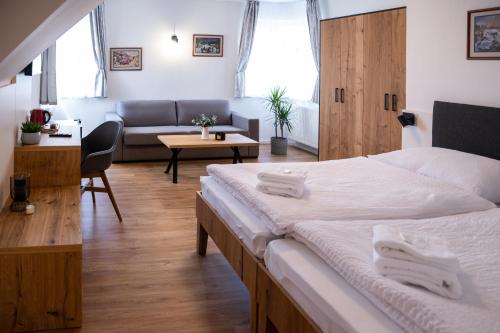 a bedroom with a bed and a living room at Vila Markéta in Ledeč nad Sázavou