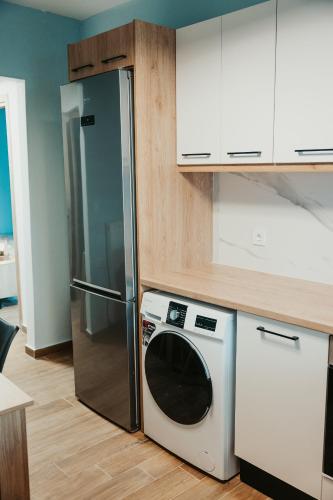 a kitchen with a refrigerator and a dishwasher at Little Villa in Makrirrákhi