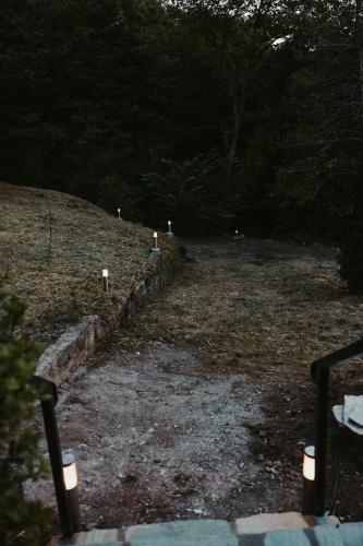 a row of candles in a field with trees at Little Villa in Makrirrákhi