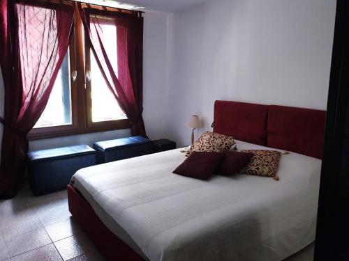 a bedroom with a large bed and a window at Appartamento Cà Lio in Venice