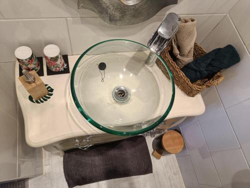 a sink with a glass bowl on top of it at Entre Bastide et Cité in Carcassonne