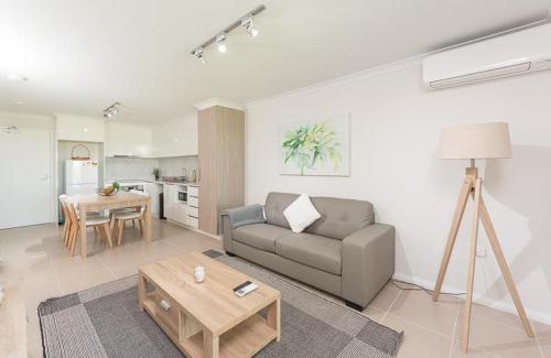 a living room with a couch and a table at Yaran Suites in Rockingham