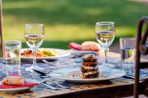 a table with plates of food and glasses of wine at Kasbah Angour in Tahannout
