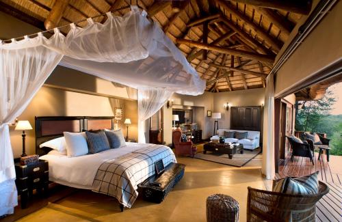 A bed or beds in a room at Lion Sands - Tinga Lodge