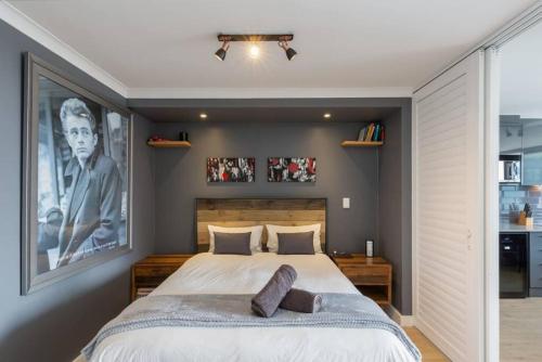 a bedroom with a large bed with two pillows on it at Trendy Bachelor Pad Free Parking Rooftop Pool in Cape Town