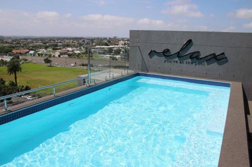 a large swimming pool on top of a building at Trendy Bachelor Pad Free Parking Rooftop Pool in Cape Town