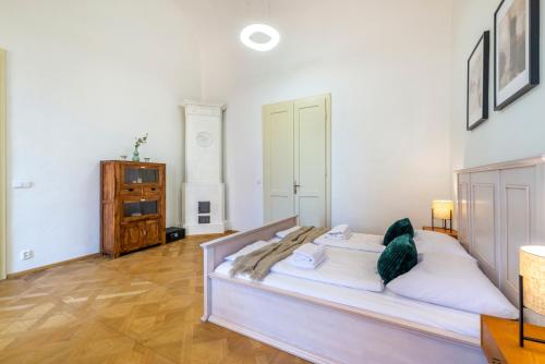 a bedroom with a bed and a dresser at Celetná - Old Town Residence in Prague