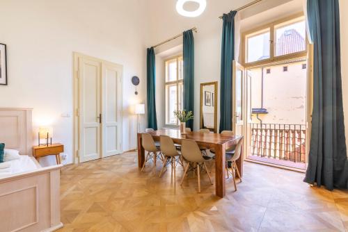 a dining room with a table and chairs at Celetná - Old Town Residence in Prague