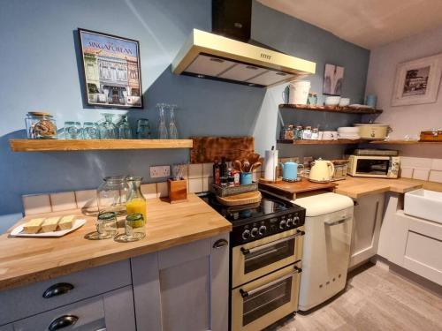 a kitchen with a stove and a counter top at Stunning Luxury Vintage Duplex with Parking in Manchester