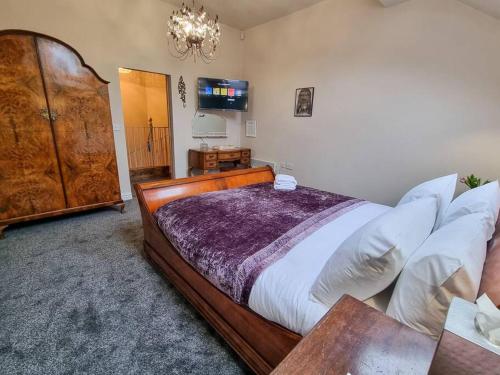 a bedroom with a large bed and a chandelier at Stunning Luxury Vintage Duplex with Parking in Manchester