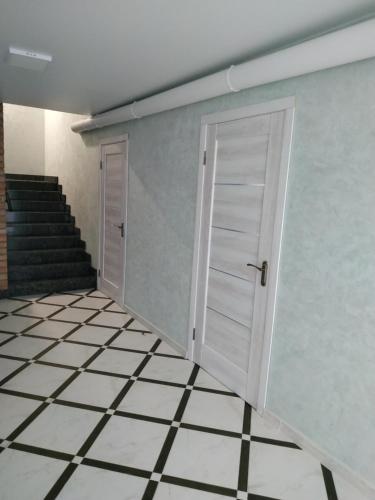 an empty room with a door and a tiled floor at Svitiaz Griada in Szack