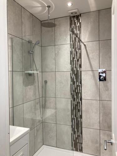 a bathroom with a shower with a glass door at The View Apartments Castle Road in Scarborough