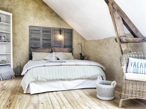 a bedroom with a large bed in a attic at Le Moulin de Trévelo in Caden