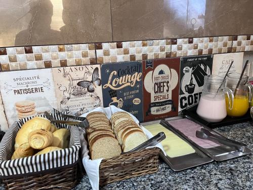 a basket of bread on a counter with some milk at Pousada Mercosul in Alegrete