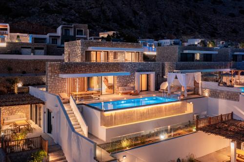 a villa with a swimming pool at night at Villa Auretta in Pefki Rhodes