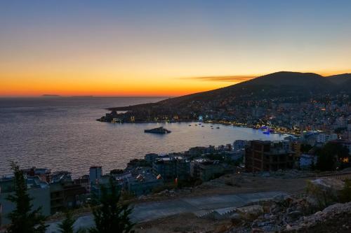 a view of a city at sunset at Sky Way SKK Luxury Apartments in Sarandë