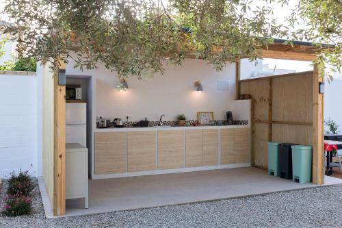 an outdoor kitchen with a counter and a refrigerator at Glamping La Mimosa CONIL in Conil de la Frontera