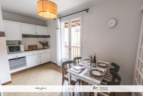 a kitchen and dining room with a table and chairs at Appartement VILLA PAULA Ax-les-Thermes in Ax-les-Thermes