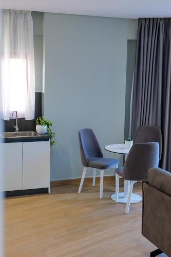 a living room with two chairs and a table at Sky Way SKK Luxury Apartments in Sarandë