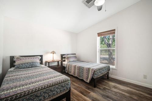 a bedroom with two beds and a window at Spanish Valley Vinyard in Moab