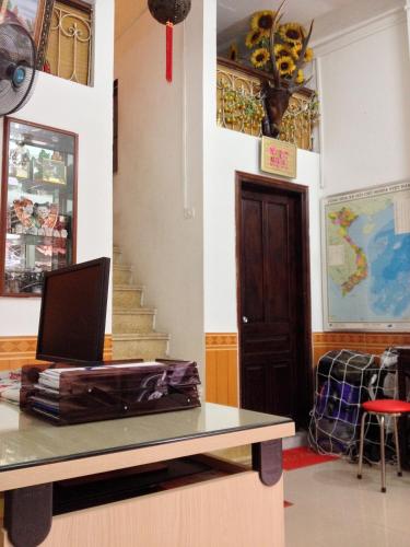 a room with a table with a laptop on it at North Hostel N.2 in Hanoi