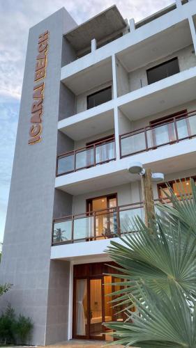 a white building with a hotel sign on it at Hotel Icaraí Beach in Icaraí