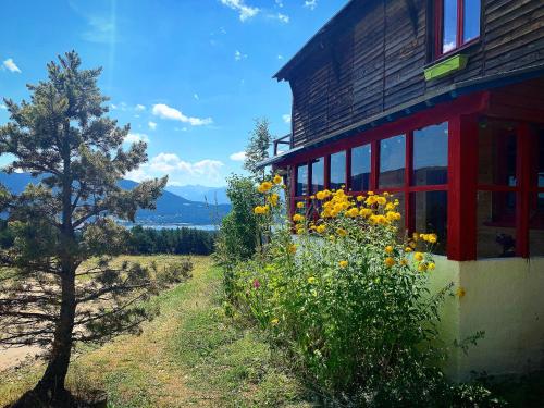 a house with a field of flowers next to a building at Gîte Ranch Le Serpolet in Les Angles