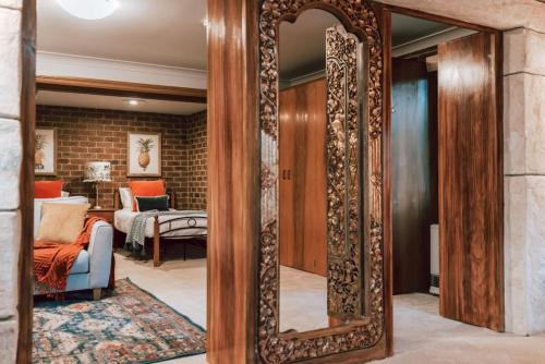 a large mirror in a room with a living room at Olinda Sandstone Apartment 2 Bedroom Spa bath in Olinda