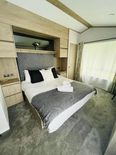 a bedroom with a large bed in a room at Fir Tree Lodge with Hot Tub in York