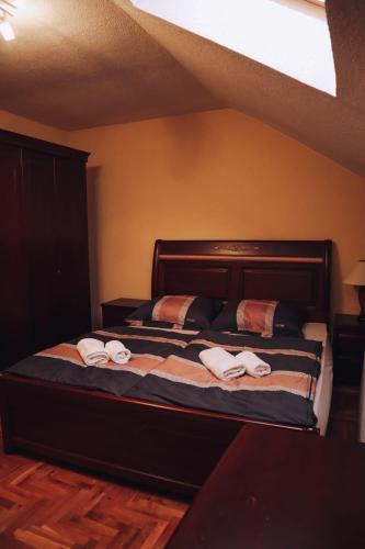 a bedroom with a bed with towels on it at Villa Sami in Bihać