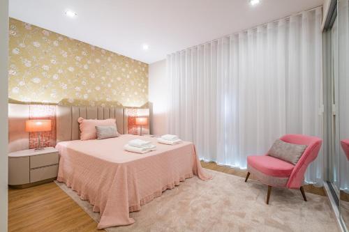 a bedroom with a pink bed and a pink chair at Urban Paradise by Homie in Funchal