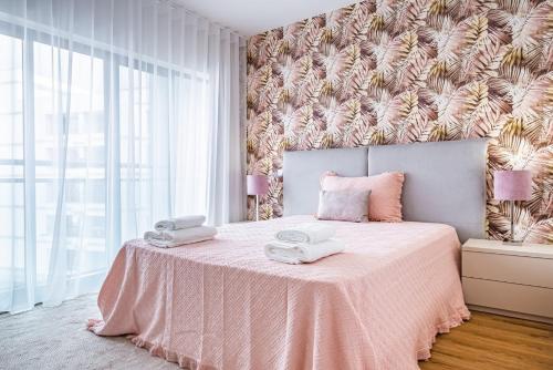 a bedroom with a pink bed with a pink blanket at Urban Paradise by Madeira Sun Travel in Funchal
