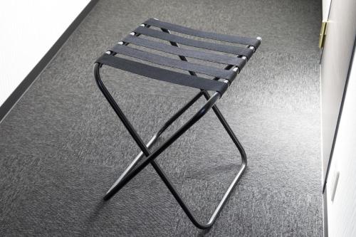 a black chair sitting on top of a carpet at Green Rich Hotel Izumo (Artificial hot spring Futamata Yunohana) in Izumo
