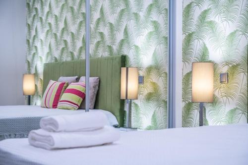 a hotel room with two beds with towels on them at Urban Paradise by Homie in Funchal