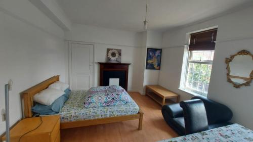 a bedroom with a bed and a chair in it at London Edgware Station Apartment in London