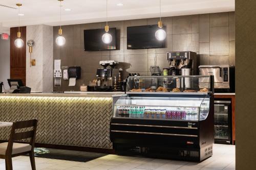 a bakery with a display of pastries on a counter at APA Hotel Woodbridge in Iselin