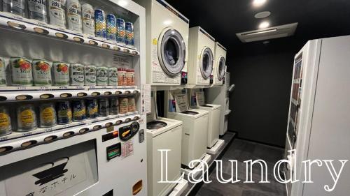 a laundry room with a refrigerator and lots of drinks at Henn na Hotel Tokyo Haneda in Tokyo