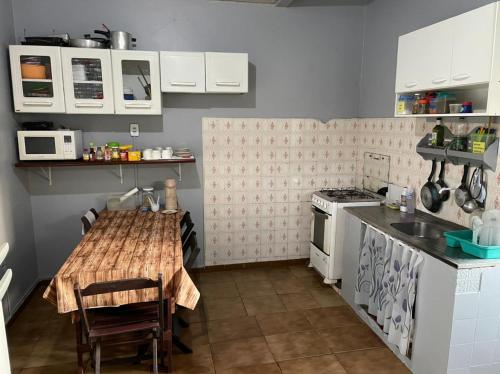 a small kitchen with a table and a stove at Discovery hostel in Manaus